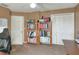 This home office offers a storage closet, ceiling fan and shelving for organization at 3507 Autumn Glen Dr, Valrico, FL 33596