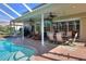Covered patio featuring outdoor dining and lounge furniture next to the inviting swimming pool at 3507 Autumn Glen Dr, Valrico, FL 33596