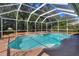 Large screened-in pool and spa surrounded by lush greenery, offering a private retreat at 3507 Autumn Glen Dr, Valrico, FL 33596