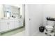 Bright bathroom featuring a double vanity with white cabinets, light countertops, and tile flooring at 4035 Radiant Mountain Dr, Plant City, FL 33565