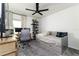 Bedroom with a stylish desk, comfortable bed, and a ceiling fan for comfort and relaxation at 4035 Radiant Mountain Dr, Plant City, FL 33565