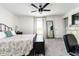 Cozy bedroom featuring a large bed, natural light and a ceiling fan, perfect for relaxation at 4035 Radiant Mountain Dr, Plant City, FL 33565
