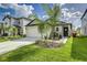 Charming single-Gathering home with a well-manicured lawn, two-car garage and beautiful landscaping at 4035 Radiant Mountain Dr, Plant City, FL 33565