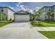 Exterior view of a well-maintained home with a spacious two-car garage and neat landscaping at 4035 Radiant Mountain Dr, Plant City, FL 33565