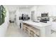 Modern kitchen featuring white cabinets, stainless steel appliances, and a large center island with bar seating at 4035 Radiant Mountain Dr, Plant City, FL 33565