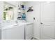 Bright laundry room featuring modern washer and dryer, shelving and ample storage space at 4035 Radiant Mountain Dr, Plant City, FL 33565