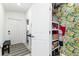 Hallway shot including the pantry with bright floral wallpaper at 4035 Radiant Mountain Dr, Plant City, FL 33565