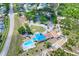 Overhead view showcasing community amenities, including a pool, tennis courts, and parking at 8721 Latham Ln, Hudson, FL 34667