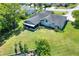 Aerial view showcases home, well-manicured lawn, landscaping, and the neighborhood at 8721 Latham Ln, Hudson, FL 34667