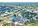 Expansive aerial view of a residential community with a community center, pool, and sports courts at 8721 Latham Ln, Hudson, FL 34667