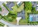 Aerial view shows the home with a long driveway and lush landscaping in a quiet neighborhood at 8721 Latham Ln, Hudson, FL 34667