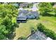 Aerial view of the home with a spacious lawn, landscaping, and neighborhood at 8721 Latham Ln, Hudson, FL 34667