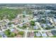 Aerial view showcases the neighborhood, community pool, and the home with a long driveway at 8721 Latham Ln, Hudson, FL 34667