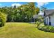 Large, green backyard with lush landscaping and exterior view of the home at 8721 Latham Ln, Hudson, FL 34667
