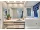 Bathroom featuring a vanity with sink, tub-shower combo, decorated with decorative wall art and neutral colors at 8721 Latham Ln, Hudson, FL 34667