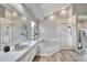 Bright bathroom boasts dual shower stalls, long vanity, wood floors, and soaking tub at 8721 Latham Ln, Hudson, FL 34667