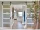 En-suite bathroom seen through sliding barn doors at 8721 Latham Ln, Hudson, FL 34667