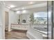 Bright bathroom features a soaking tub, wood look flooring, and a long vanity at 8721 Latham Ln, Hudson, FL 34667