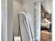Modern bedroom with full-length mirror, natural light, and sliding door to a bedroom at 8721 Latham Ln, Hudson, FL 34667