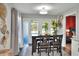 Dining area features table with seating and sliding glass doors for natural light at 8721 Latham Ln, Hudson, FL 34667