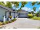 Side angle of the home highlighting the extra long driveway and well-maintained landscaping at 8721 Latham Ln, Hudson, FL 34667