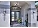 Close up of the front door featuring sidelights and an arched transom window at 8721 Latham Ln, Hudson, FL 34667