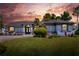 Beautiful single-story home featuring a well-manicured lawn and a symmetrical facade with a double-door entrance at 8721 Latham Ln, Hudson, FL 34667