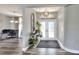 Welcoming foyer with decorative console table, stylish lighting, and double doors at 8721 Latham Ln, Hudson, FL 34667