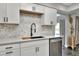 Bright kitchen boasts white cabinets, stainless steel appliances, and modern fixtures at 8721 Latham Ln, Hudson, FL 34667