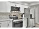 Contemporary kitchen featuring stainless steel appliances and white cabinetry at 8721 Latham Ln, Hudson, FL 34667