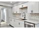 Modern kitchen features white cabinets, stainless steel appliances, and tiled backsplash at 8721 Latham Ln, Hudson, FL 34667
