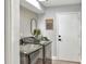 Laundry room equipped with front load washer and dryer, a door leading to a hallway, and natural light at 8721 Latham Ln, Hudson, FL 34667