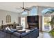 Spacious living room with fireplace, large sectional, and plenty of seating at 8721 Latham Ln, Hudson, FL 34667