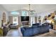 Spacious living room with large windows, an electric fireplace, hardwood floors, and modern decor at 8721 Latham Ln, Hudson, FL 34667