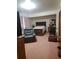 The cozy bedroom features a dark-wood bed frame, matching dresser, and comfortable seating at 1002 W La Salle St, Tampa, FL 33607
