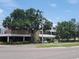 A commercial building is presented amidst lush trees and well-maintained landscaping at 1002 W La Salle St, Tampa, FL 33607