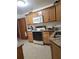 A functional kitchen offers a range with an overhead microwave and tile flooring at 1002 W La Salle St, Tampa, FL 33607