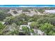 Aerial view showcasing the surrounding trees, rooftops, and roadways at 11704 Raintree Village Blvd # B, Temple Terrace, FL 33617