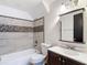 This bathroom is fitted with decorative tiling, a sink, and bathtub at 11704 Raintree Village Blvd # B, Temple Terrace, FL 33617