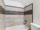 This bathroom features decorative wall tile above the tub at 11704 Raintree Village Blvd # B, Temple Terrace, FL 33617