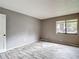 Comfortable bedroom with wood-look floors, a large window, and a convenient closet nearby at 11704 Raintree Village Blvd # B, Temple Terrace, FL 33617