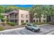 Charming condo building featuring private screened-in balconies and reserved parking in a lush, green community at 11704 Raintree Village Blvd # B, Temple Terrace, FL 33617