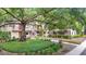 Inviting condo building featuring lush landscaping and an attractive stairwell to the upper units at 11704 Raintree Village Blvd # B, Temple Terrace, FL 33617