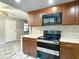 Modern kitchen features stainless steel appliances, granite counters, and abundant cabinet storage at 11704 Raintree Village Blvd # B, Temple Terrace, FL 33617