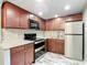 Modern kitchen with stainless steel appliances, sleek countertops, and ample cabinet space at 11704 Raintree Village Blvd # B, Temple Terrace, FL 33617
