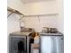 Modern laundry room featuring Samsung washer and dryer with wire rack shelving above at 11704 Raintree Village Blvd # B, Temple Terrace, FL 33617