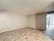 Spacious living room featuring wood-style tile floors and neutral paint, perfect for modern living at 11704 Raintree Village Blvd # B, Temple Terrace, FL 33617