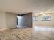 Open-concept living room showcasing wood-look tile flooring, neutral walls, and a modern ceiling fan at 11704 Raintree Village Blvd # B, Temple Terrace, FL 33617