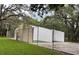 Outdoor racquetball court surrounded by chain link fence and lush grass at 11704 Raintree Village Blvd # B, Temple Terrace, FL 33617