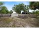 Backyard boasts a large shed and ample space for outdoor activities, surrounded by a wooden fence at 1317 E Laura St, Plant City, FL 33563